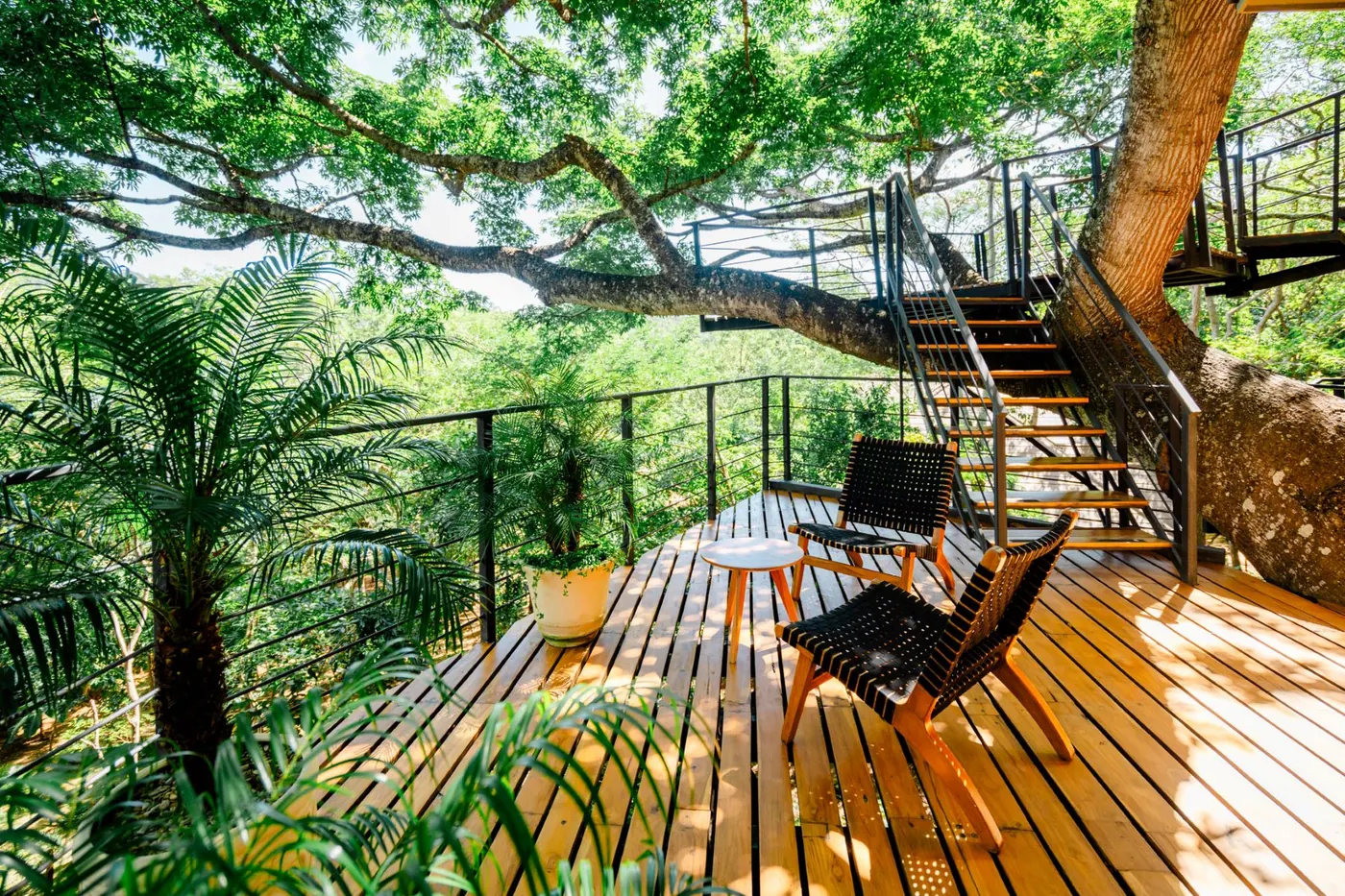 Casa Árbol at TreeCasa — two-story treehouse with thatched ceiling and ceiba views